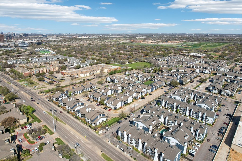 A suburban neighborhood with houses and a road.