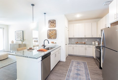 a kitchen with white cabinets and stainless steel appliances and a counter top