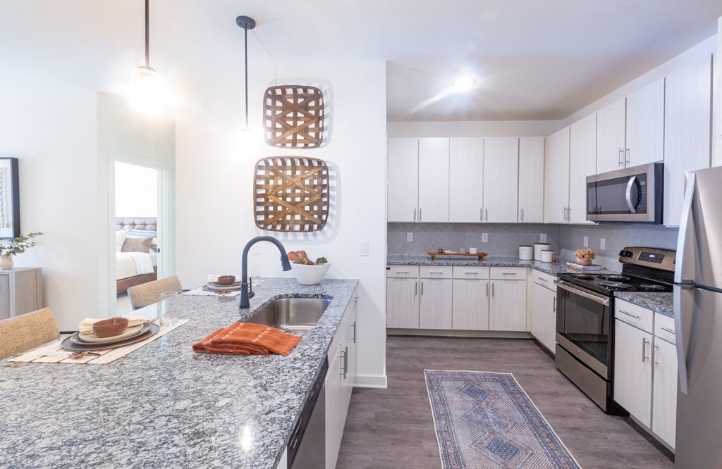 interior view of the kitchen with stainless steel appliances and granite countertop