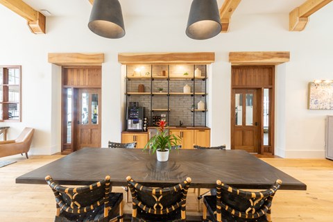 a dining room with a large table and chairs