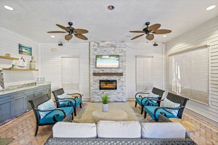 A living room with a fireplace and a television.