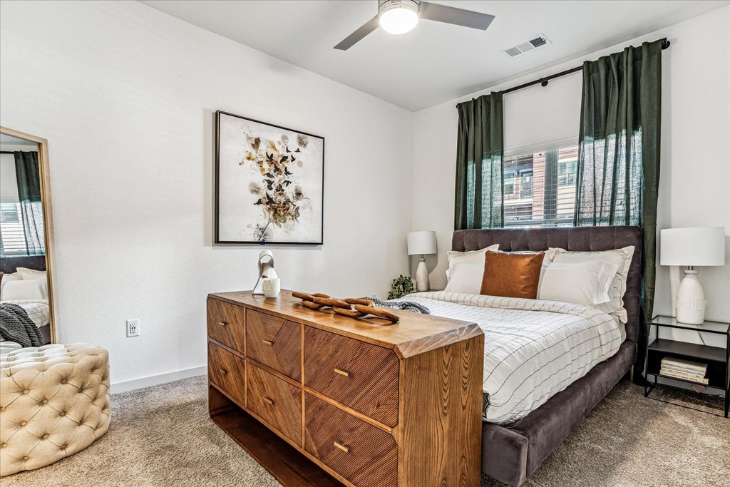 a bedroom with a bed and a dresser