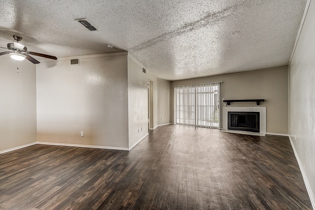 a living room with hardwood floors and a fireplace