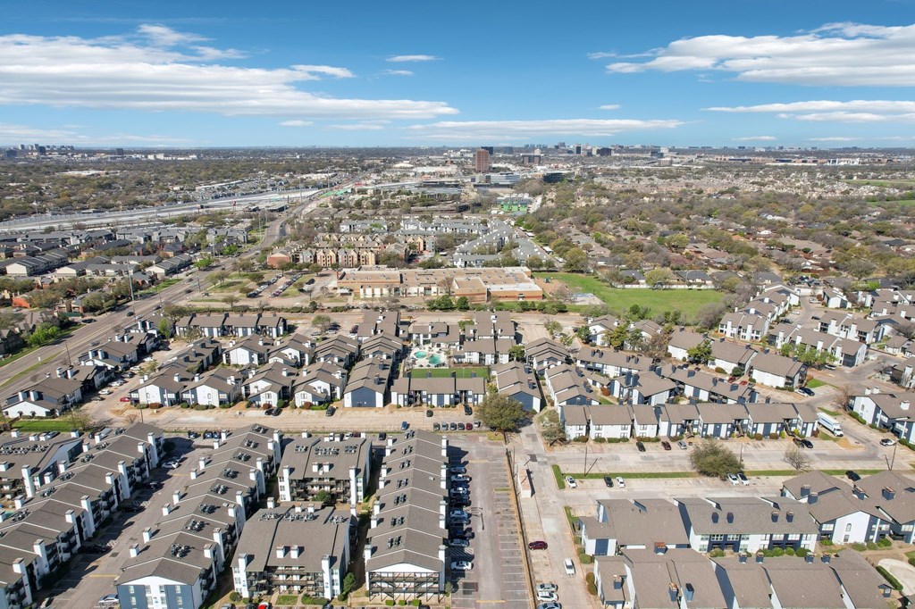A bird's eye view of a residential area with multiple houses and buildings.