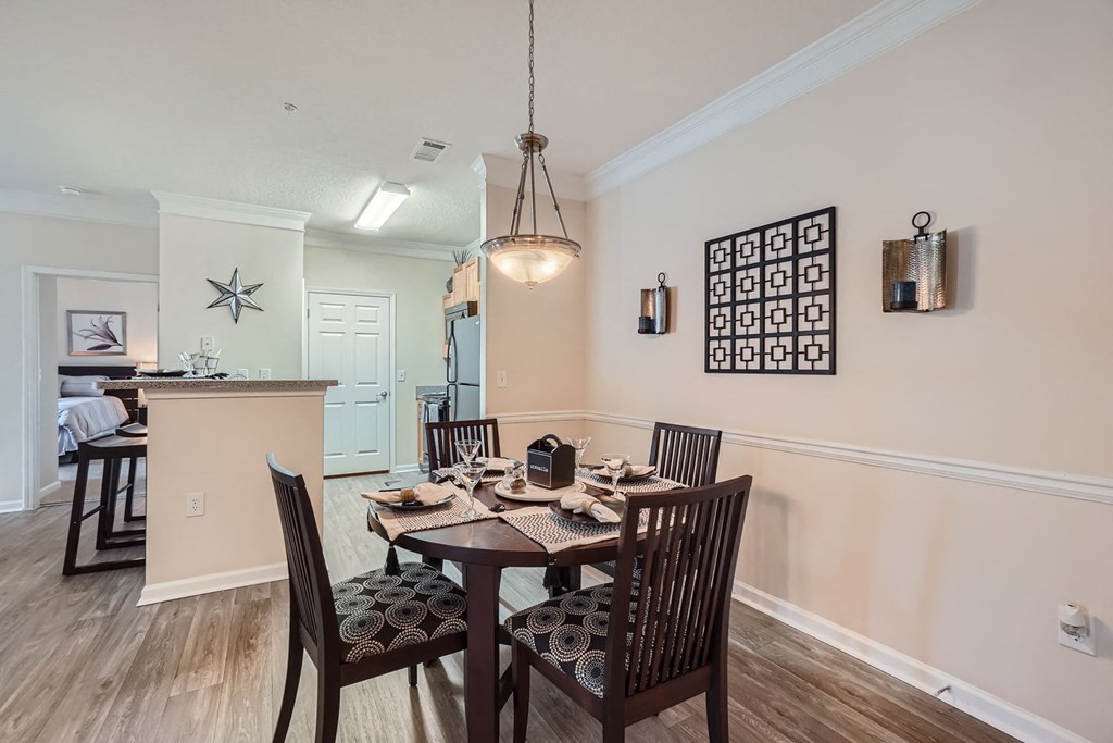 A dining room with a table set for six.