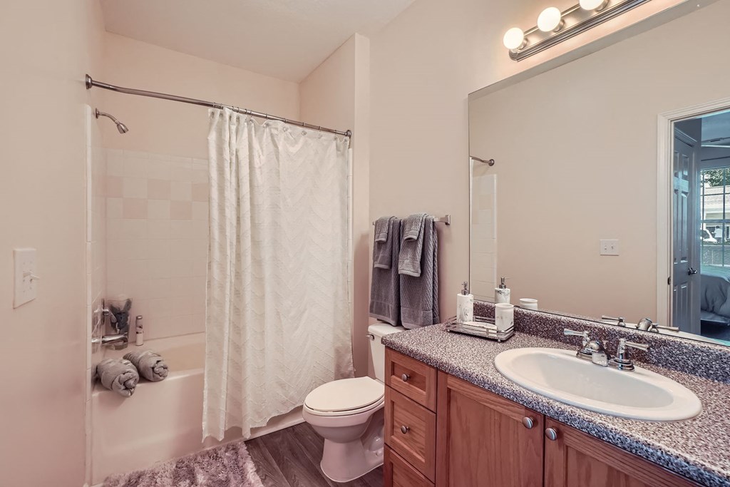 A bathroom with a toilet, sink, and shower.