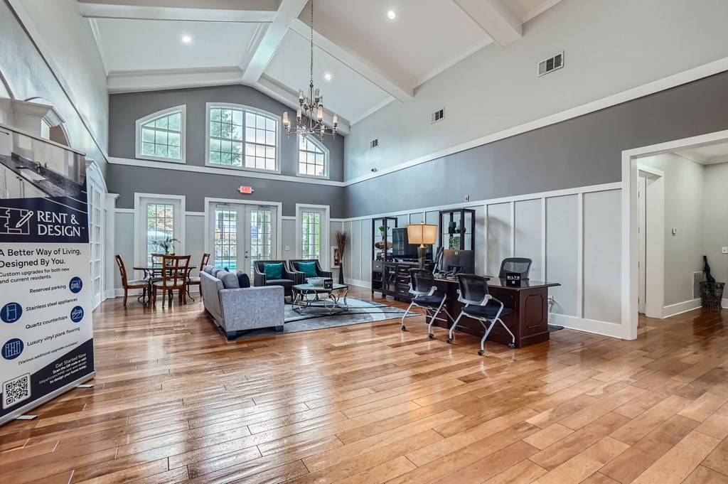 A spacious living room with hardwood floors and a variety of seating options.