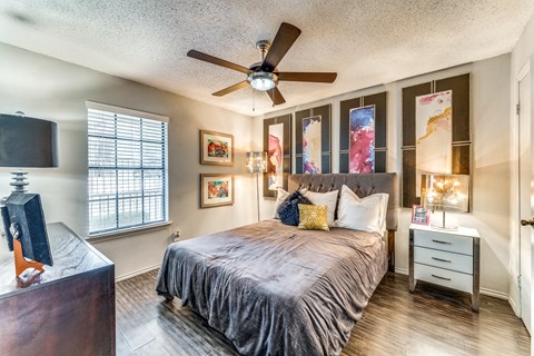 a bedroom with a large bed and a ceiling fan