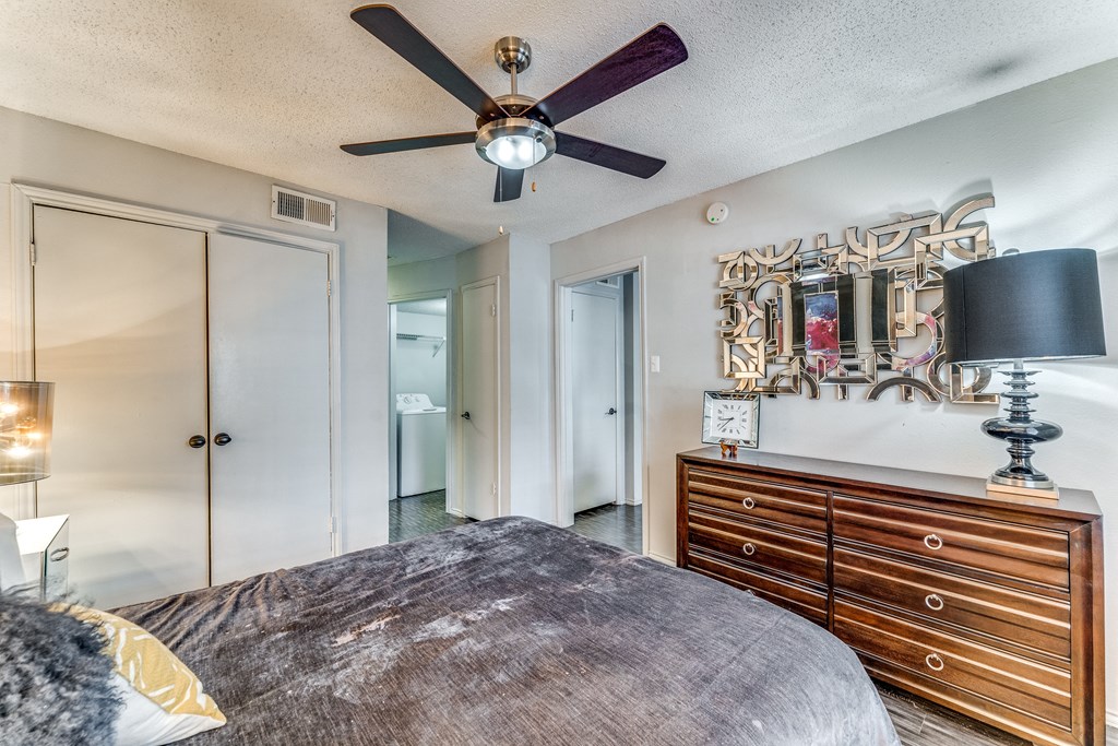 a bedroom with a bed and a ceiling fan