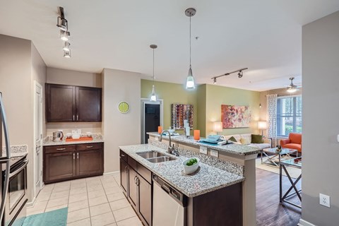 A kitchen with granite countertops and a large island.
