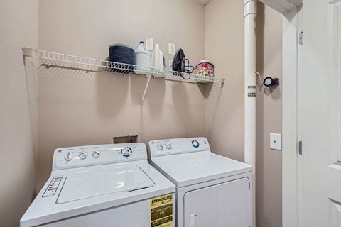A small laundry room with a washer and dryer.