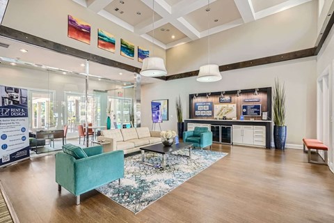 A spacious living room with a variety of furniture and a glass wall.