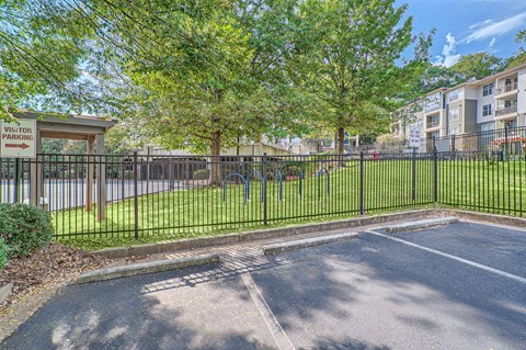 A parking lot with a sign that says "VISITOR PARKING" in front of a building.
