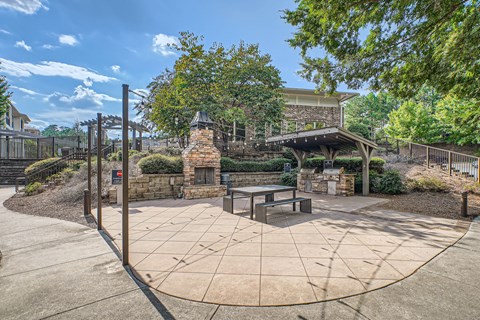 A park with a circular concrete patio and a gazebo.