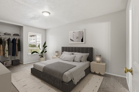 A bedroom with a large bed and a clothing rack.