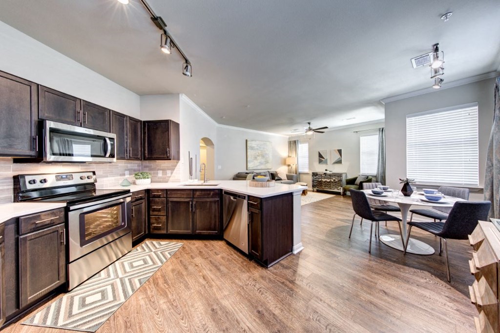 an open kitchen and living room with a table and chairs