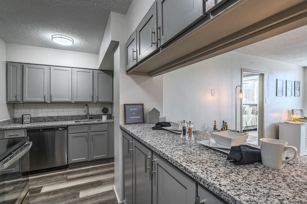 an open kitchen with granite counter tops and stainless steel appliances