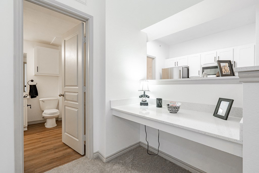 a bathroom with a mirror and a door to the toilet