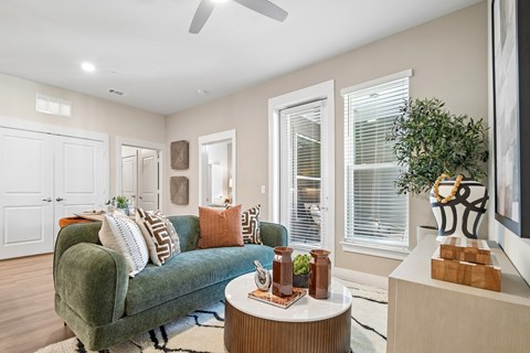 A living room with a green couch and a coffee table.
