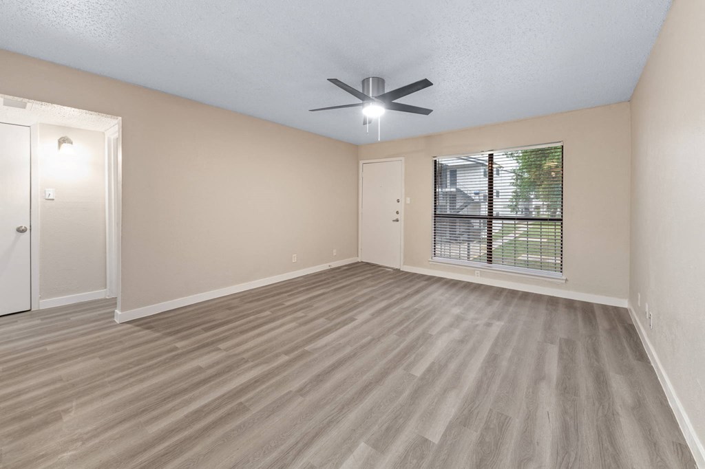 a bedroom with a ceiling fan and a window
