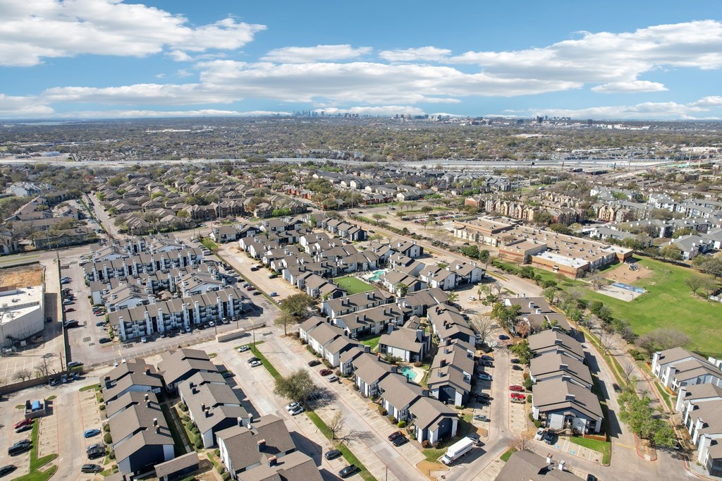 A bird's eye view of a residential area with houses and cars.