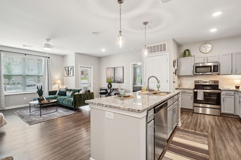 A modern kitchen with a large island and stainless steel appliances.