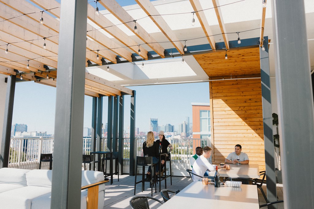 a group of people sitting at a table in a room with glass walls