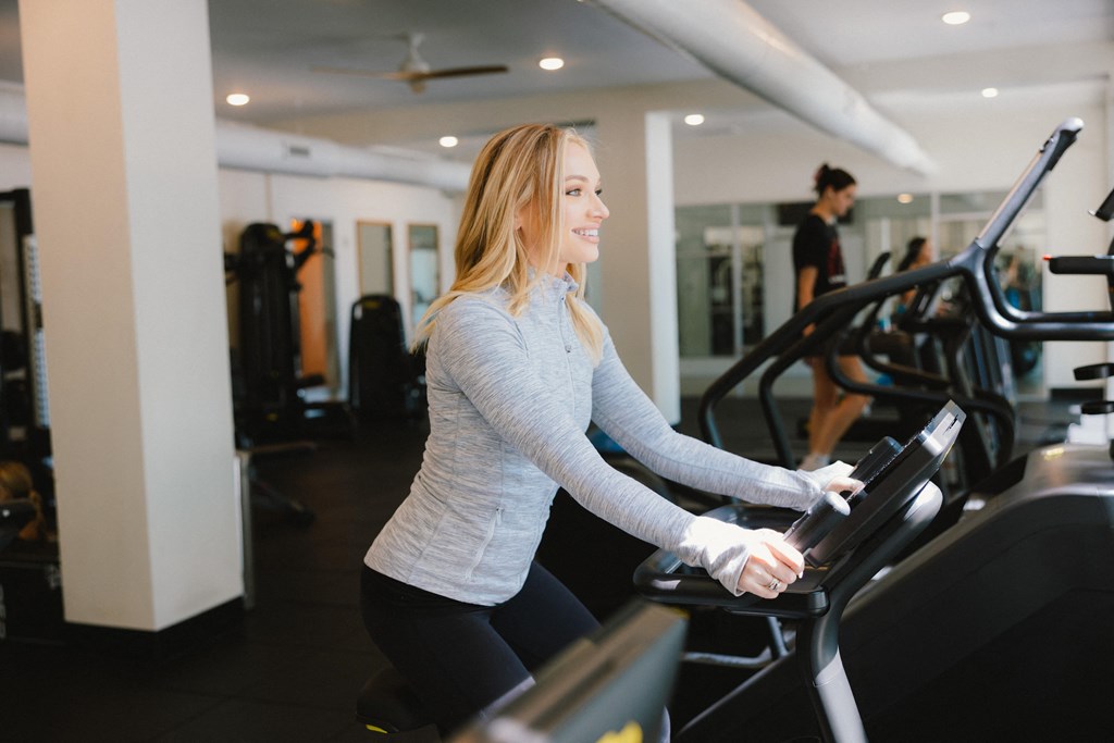 a woman exercising on a treadmill in a gym