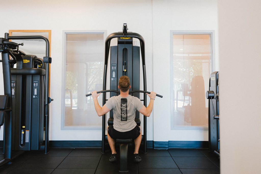 a man doing weights on a machine in a gym