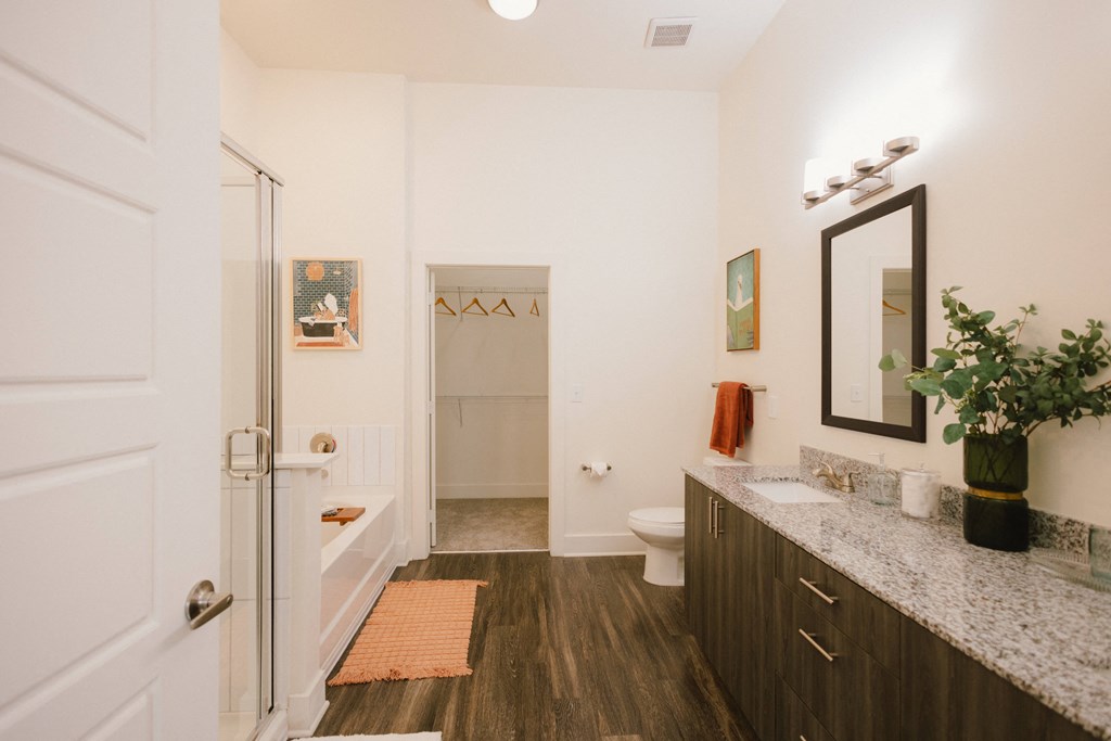 a bathroom with a shower and a sink and a mirror