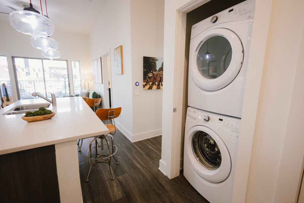 a washer and dryer in a kitchen next to a dining room with a
