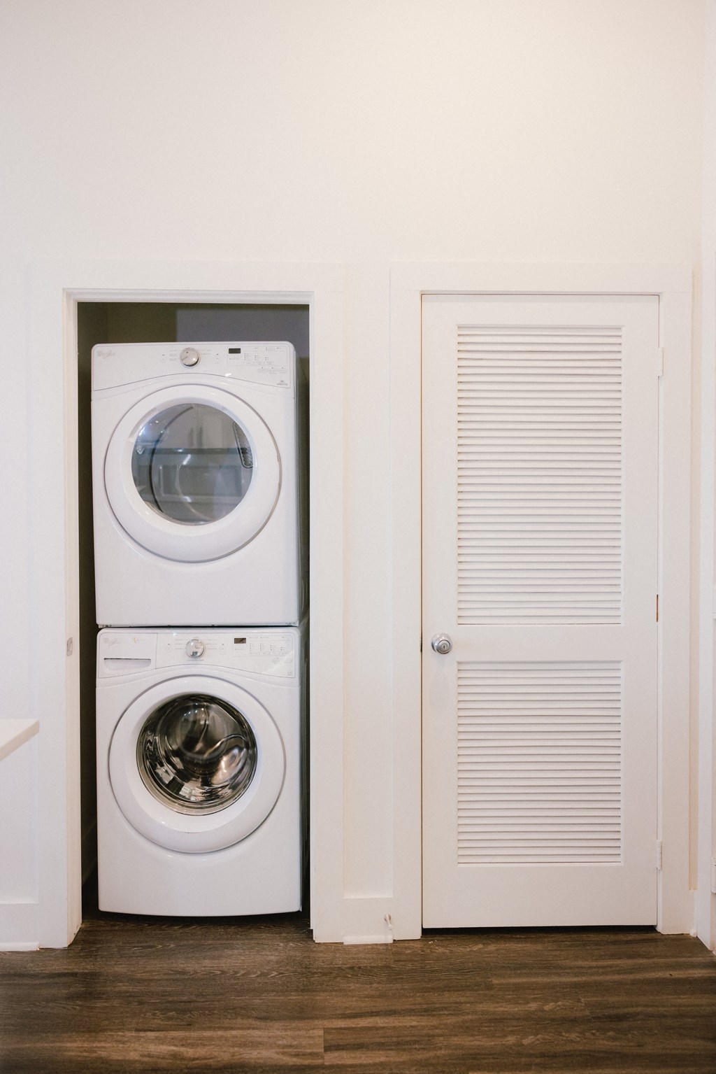 a white washer and dryer next to a white door