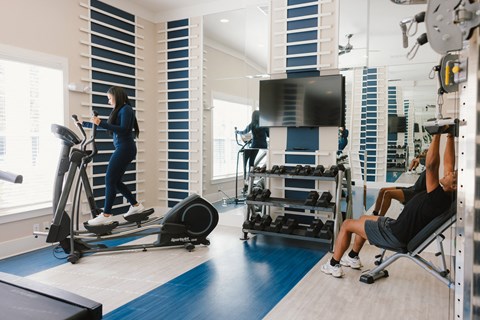 a woman exercising in a gym with a trainer