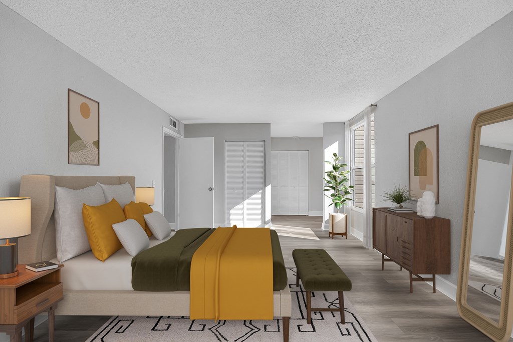 a bedroom with a bed and a yellow blanket