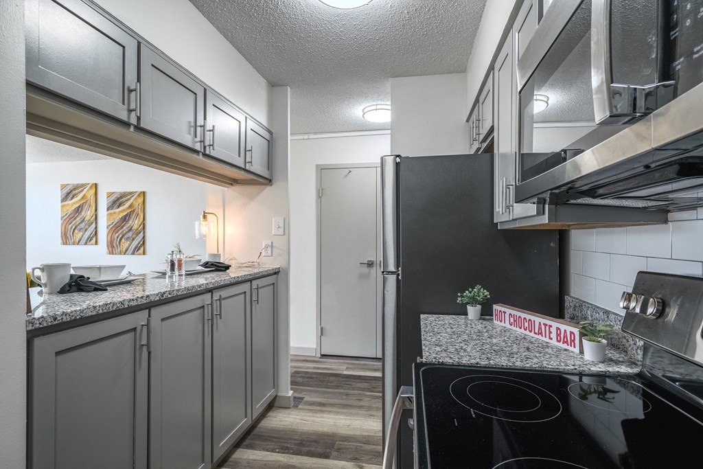 a kitchen with stainless steel appliances and granite counter tops