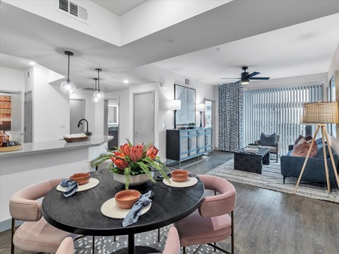 A modern dining room with a round table set for two.