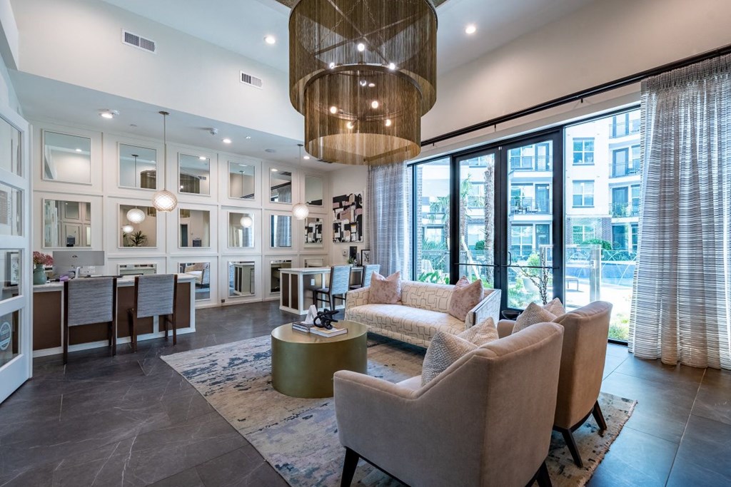 A modern living room with a large window and a view of the city.