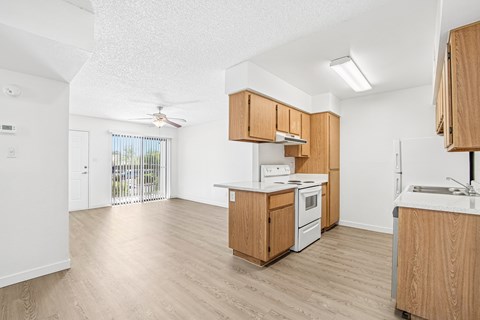 A kitchen with wooden cabinets and a white countertop.
