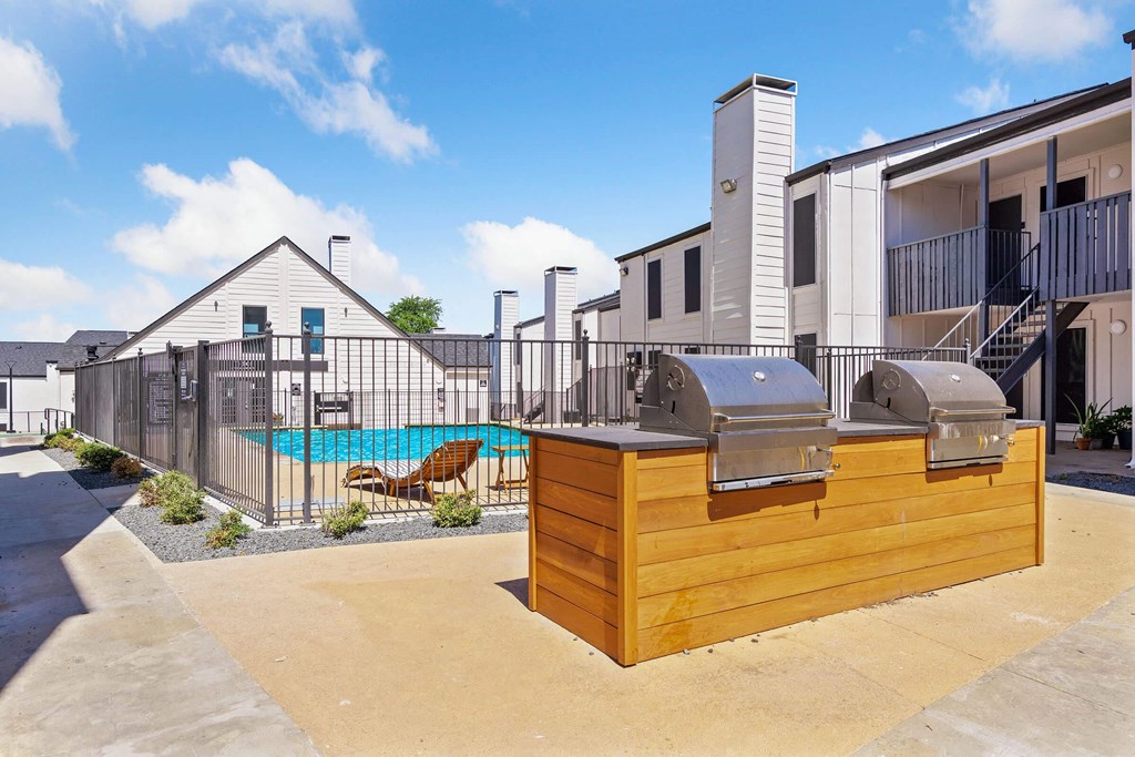 our apartments have a pool and a patio with a grill