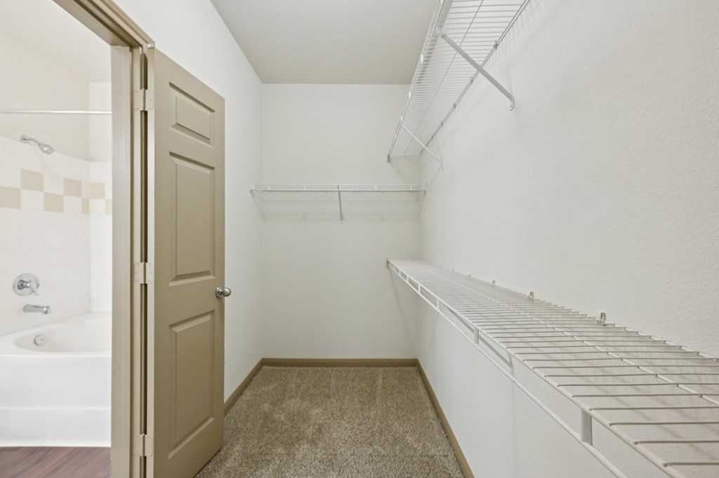 A white laundry room with a white washer and dryer.