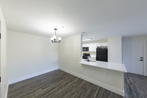A kitchen area with a counter and a fridge.