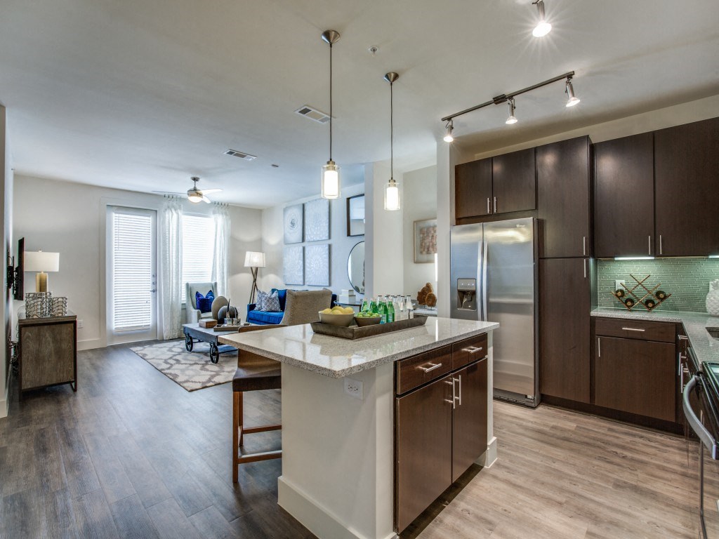 a kitchen with a large island and a living room
