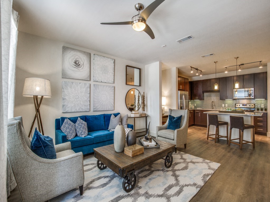 a living room with couches and chairs and a table
