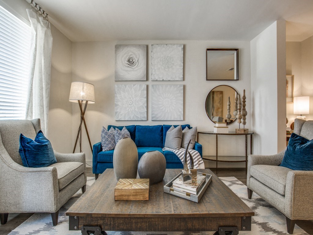 a living room with couches and chairs and a table