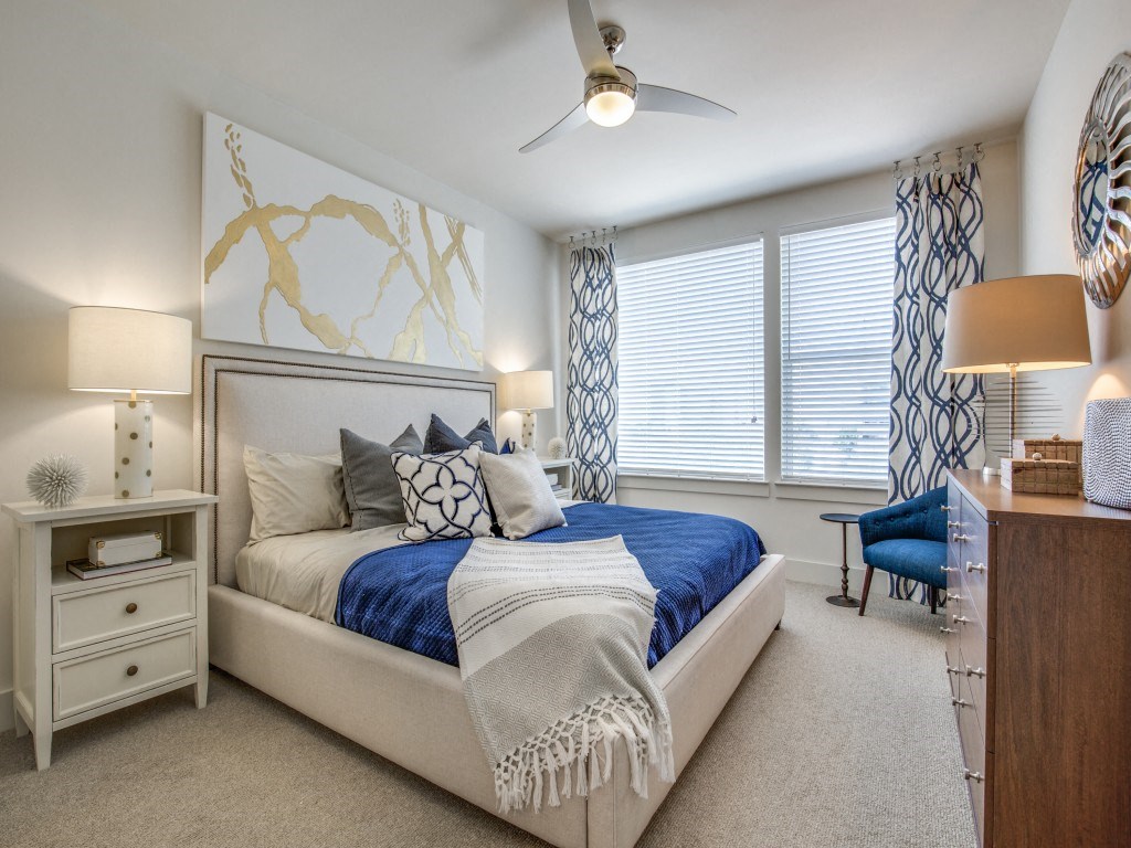 a bedroom with a bed and a ceiling fan