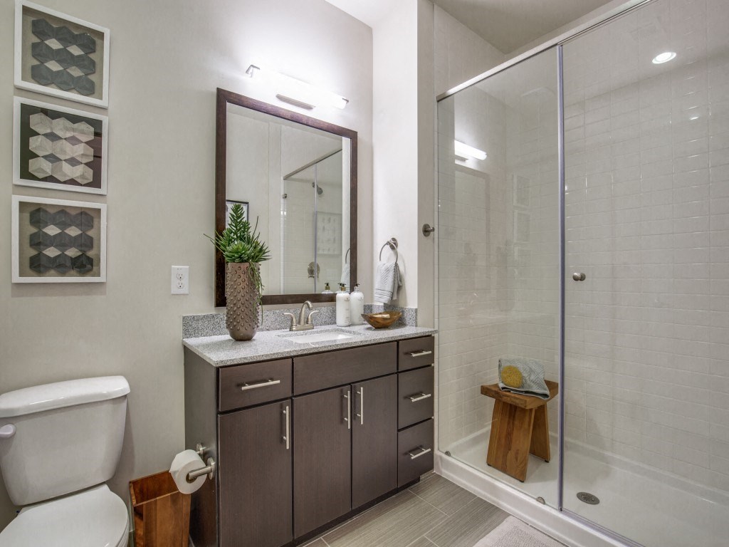 a bathroom with a toilet and a shower