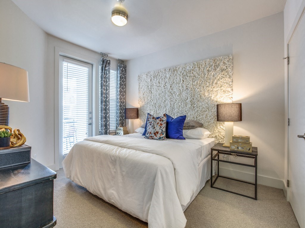 a bedroom with a large bed and a window