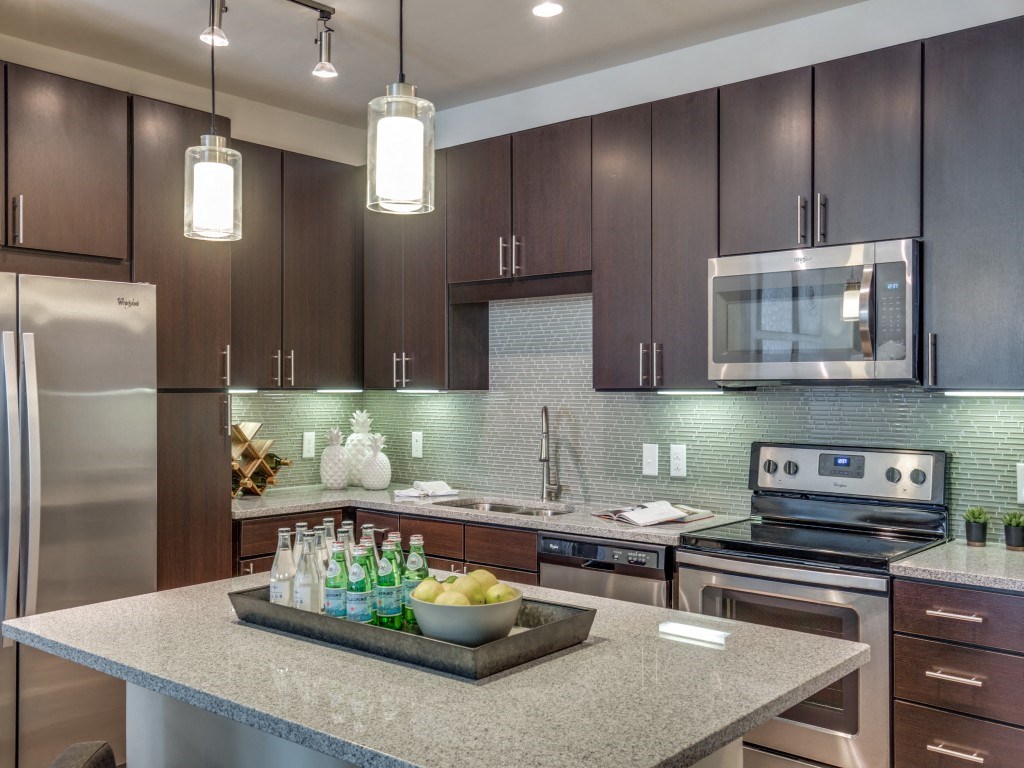 a kitchen with stainless steel appliances and wooden cabinets