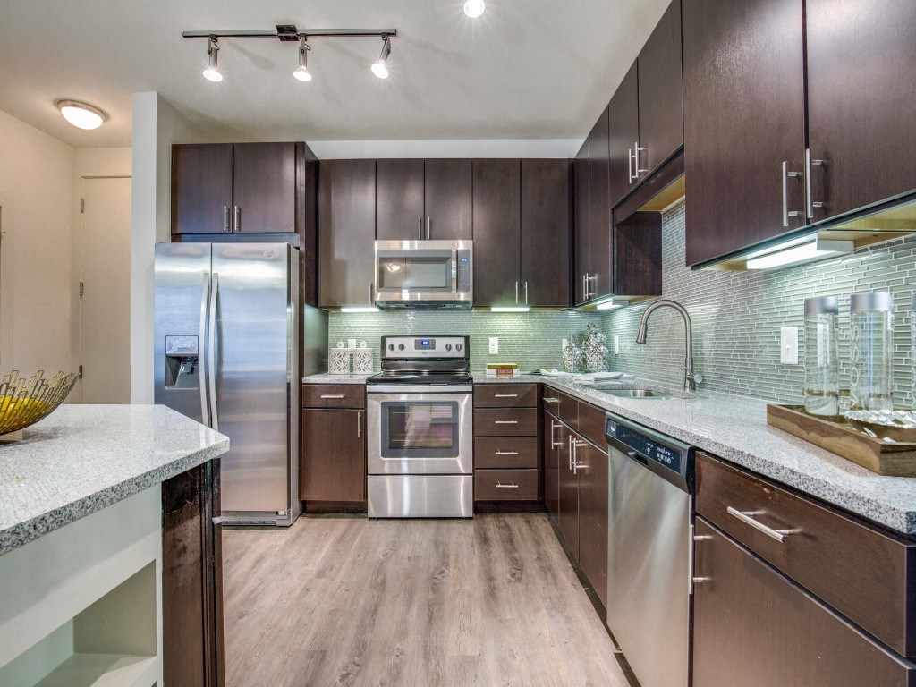 a kitchen with stainless steel appliances and wooden cabinets