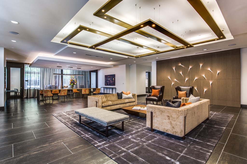 the lobby of a hotel with couches and chairs